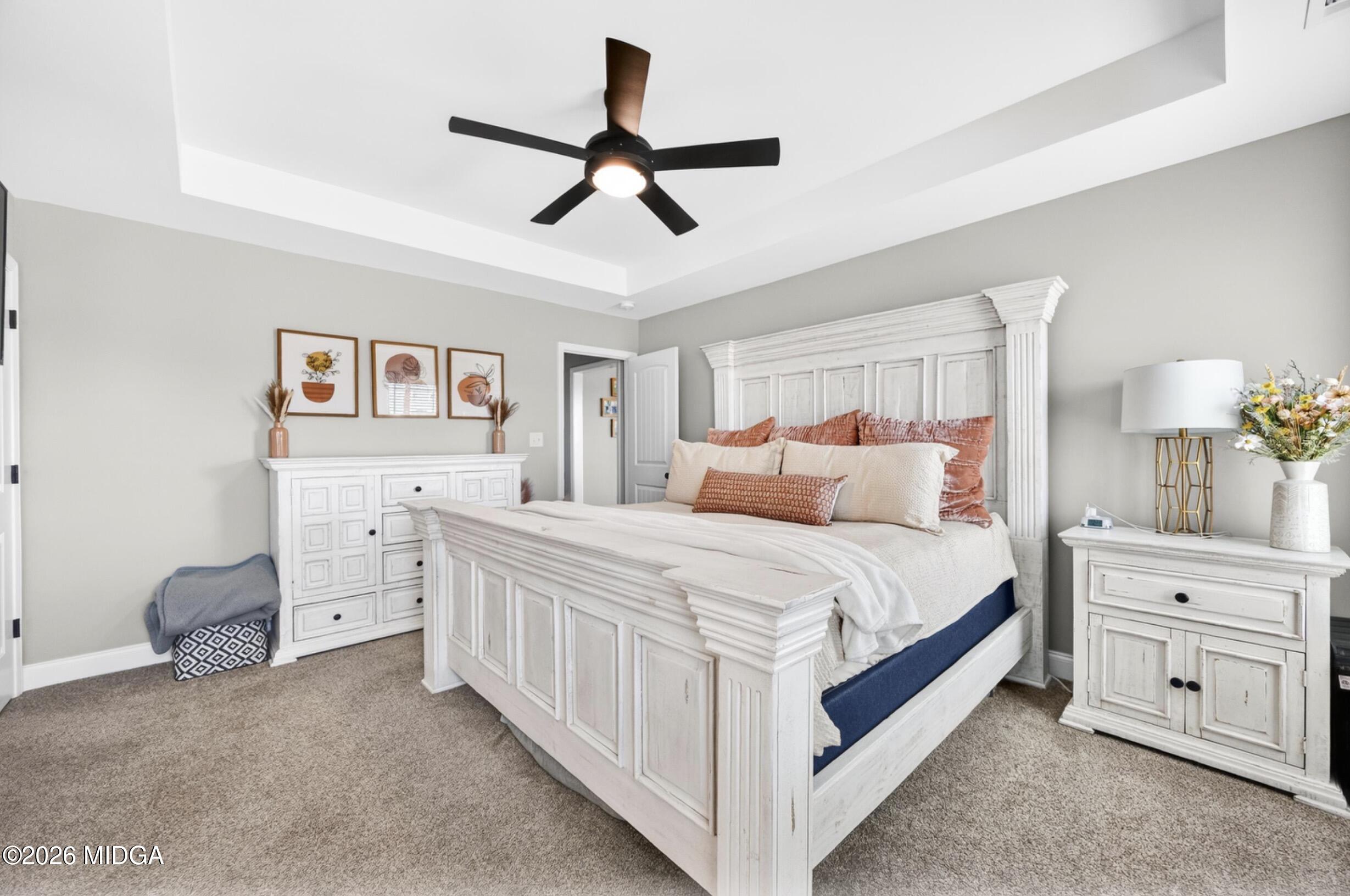 610 Daisy Drive Perry, GA 31069 - Photo 14 of 33 a bedroom with a bed and a chandelier