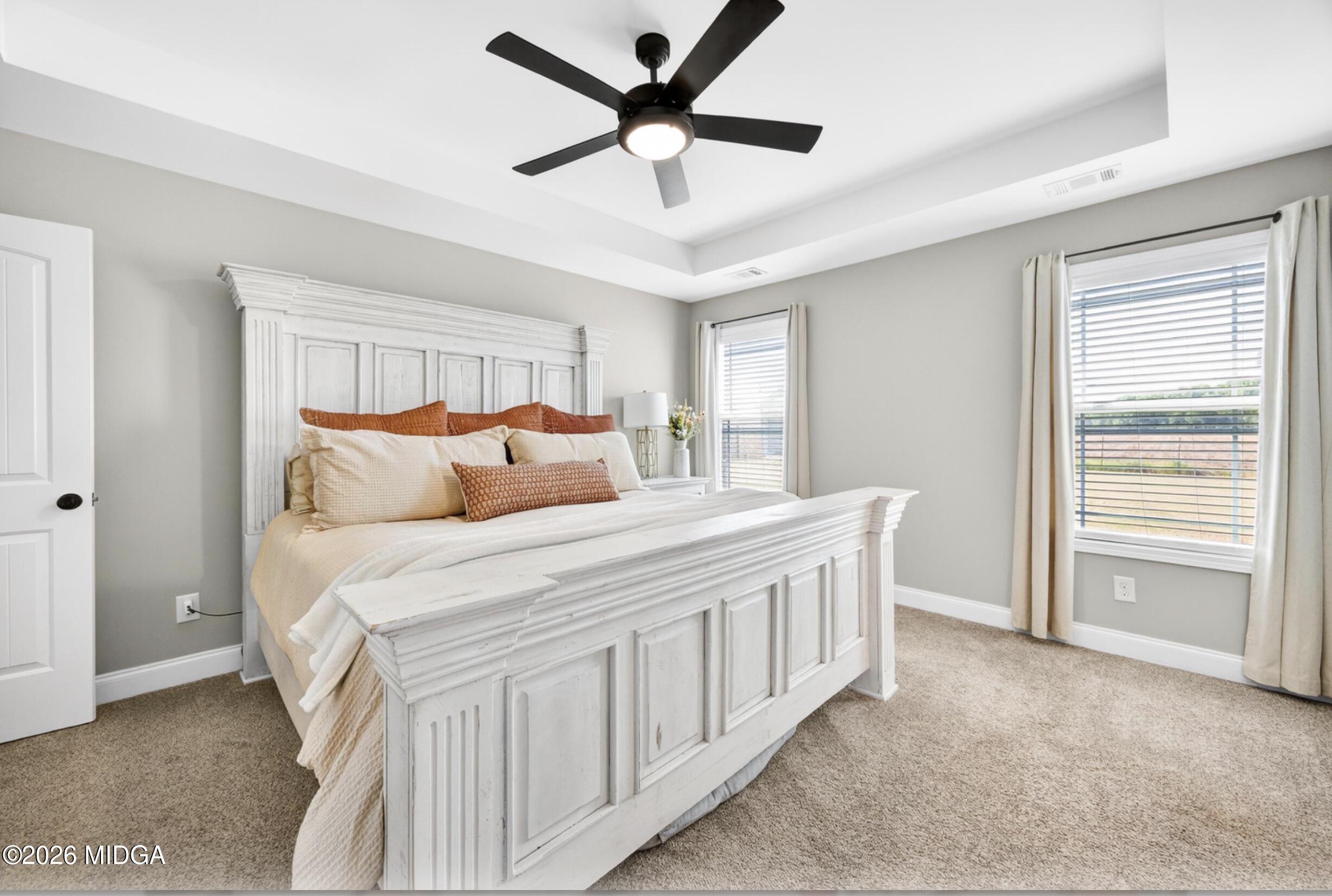 610 Daisy Drive Perry, GA 31069 - Photo 15 of 33 a bedroom with a large bed and a ceiling fan