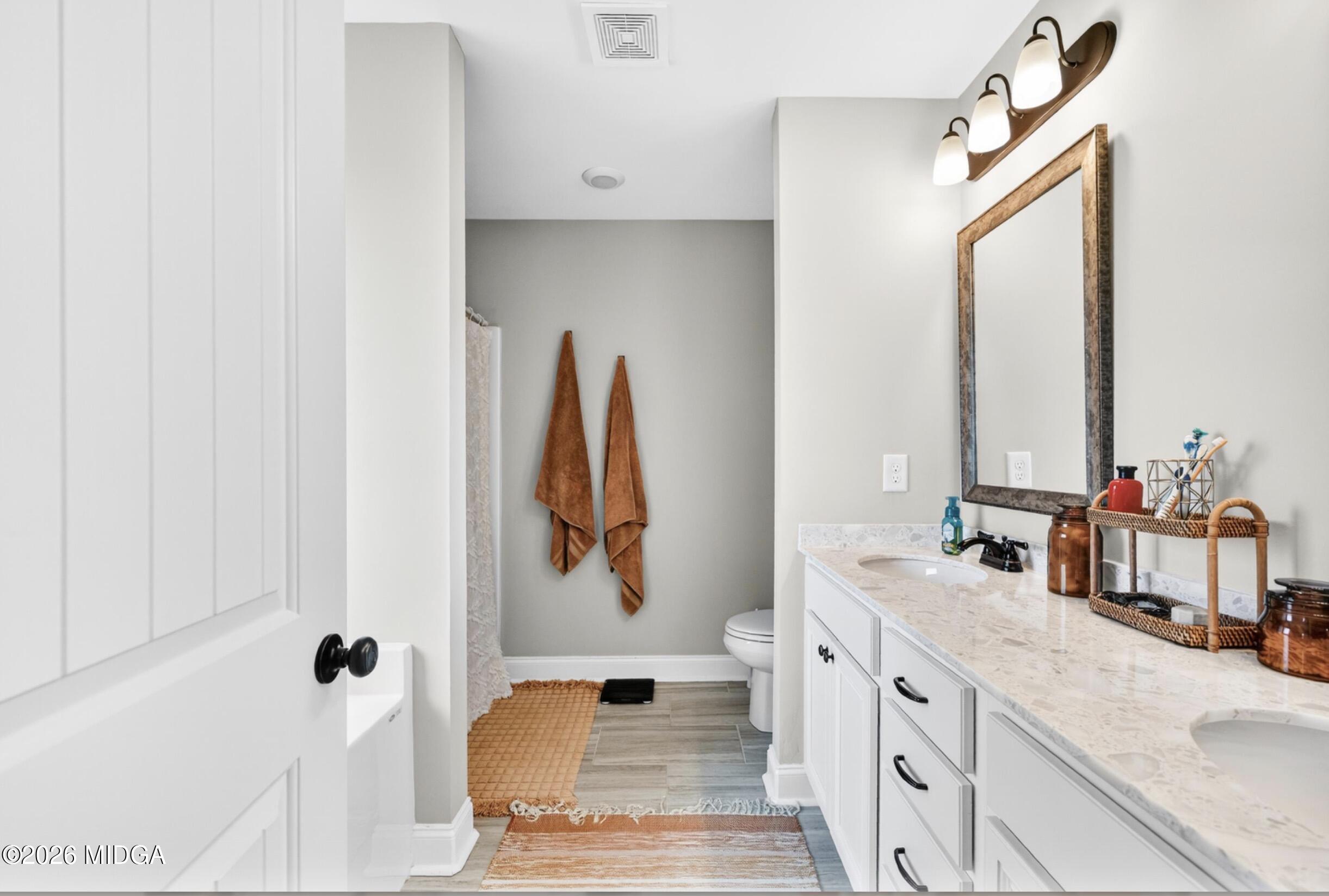610 Daisy Drive Perry, GA 31069 - Photo 18 of 33 a bathroom with a double vanity sink and mirror