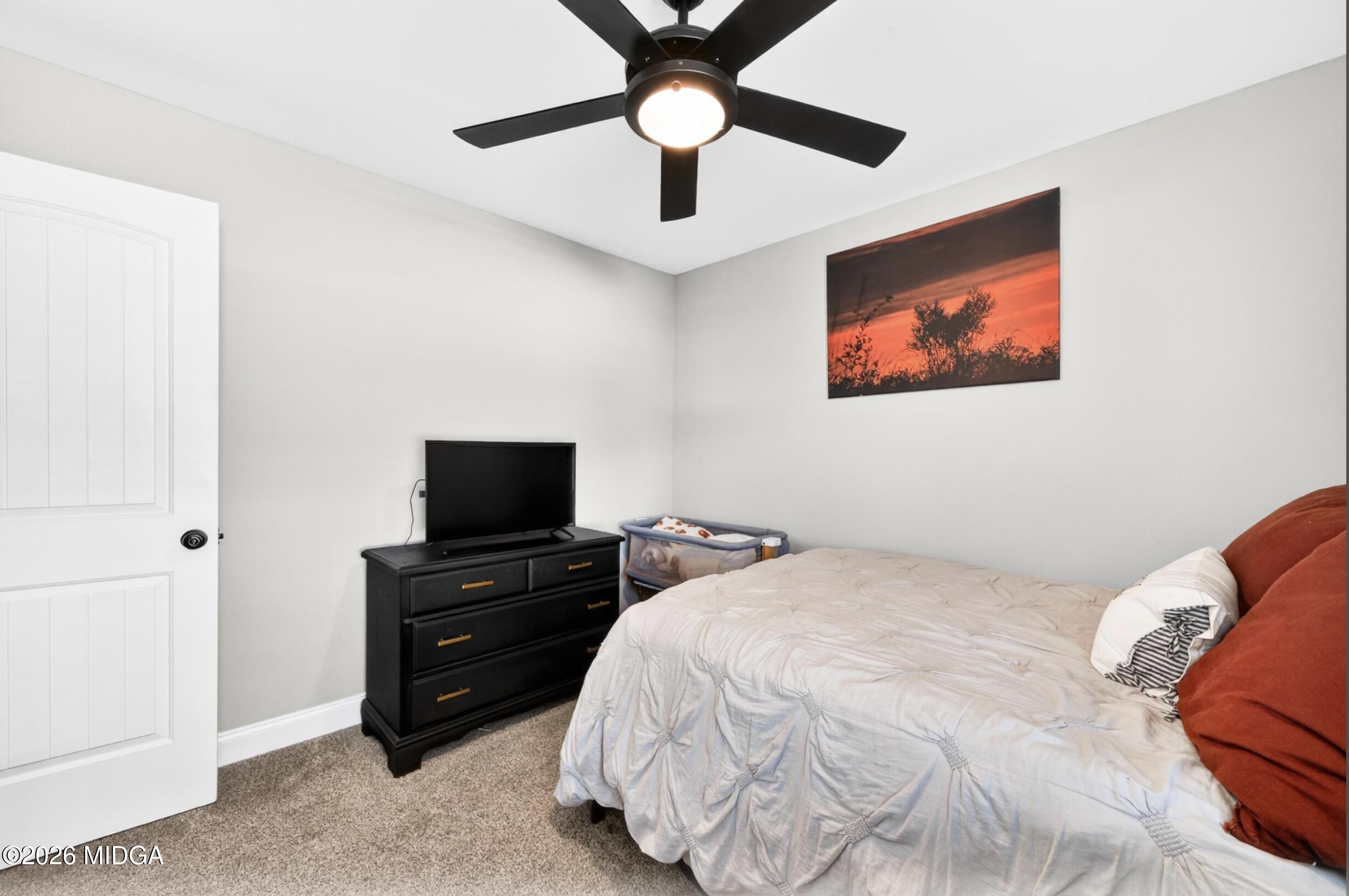 610 Daisy Drive Perry, GA 31069 - Photo 21 of 33 a bedroom with a bed and a chandelier