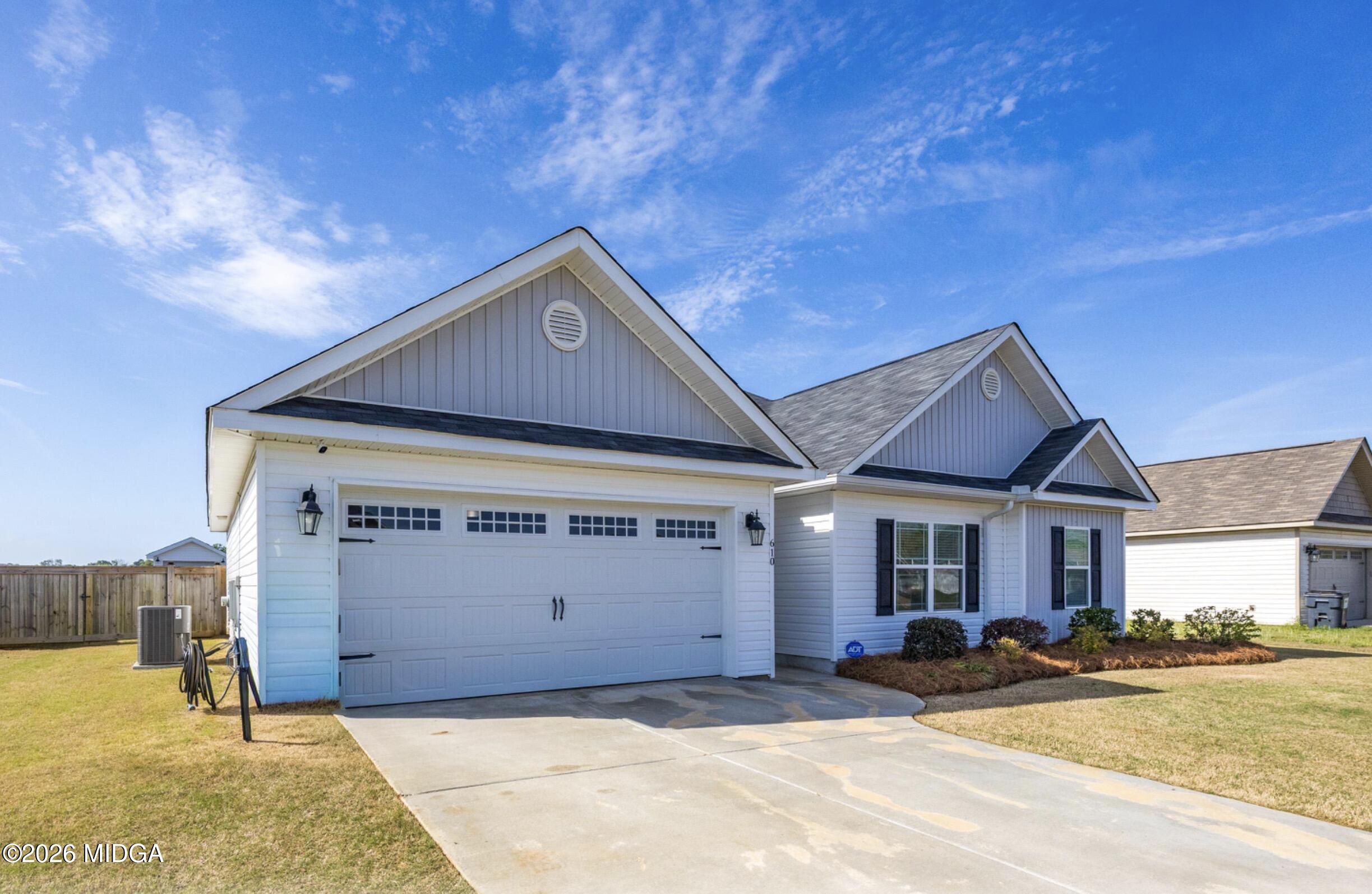 610 Daisy Drive Perry, GA 31069 - Photo 3 of 33 a front view of a house with a yard and garage