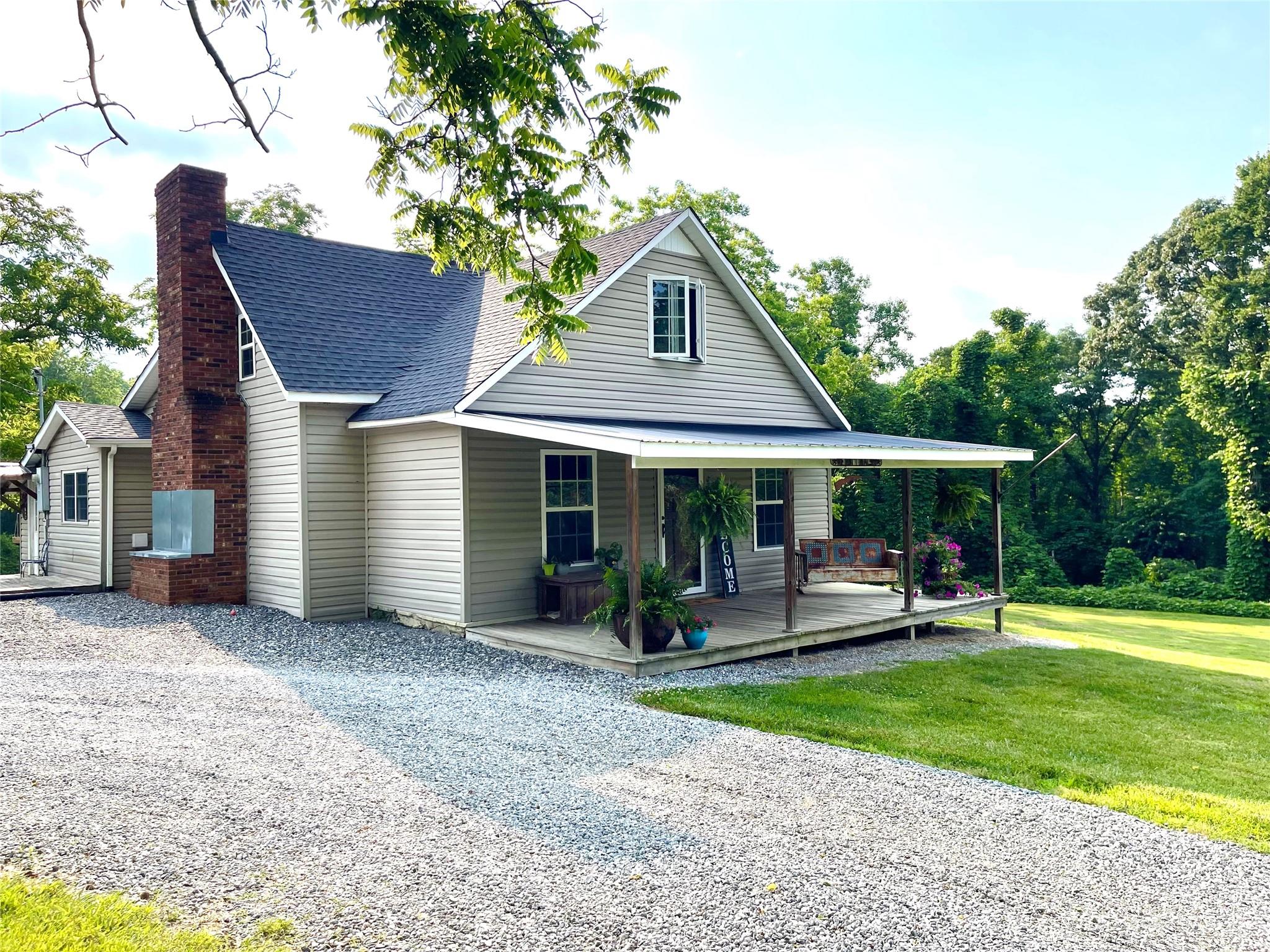 191 Lackey Road Hiddenite, NC 28636 - Photo 1 of 40 a front view of a house with garden
