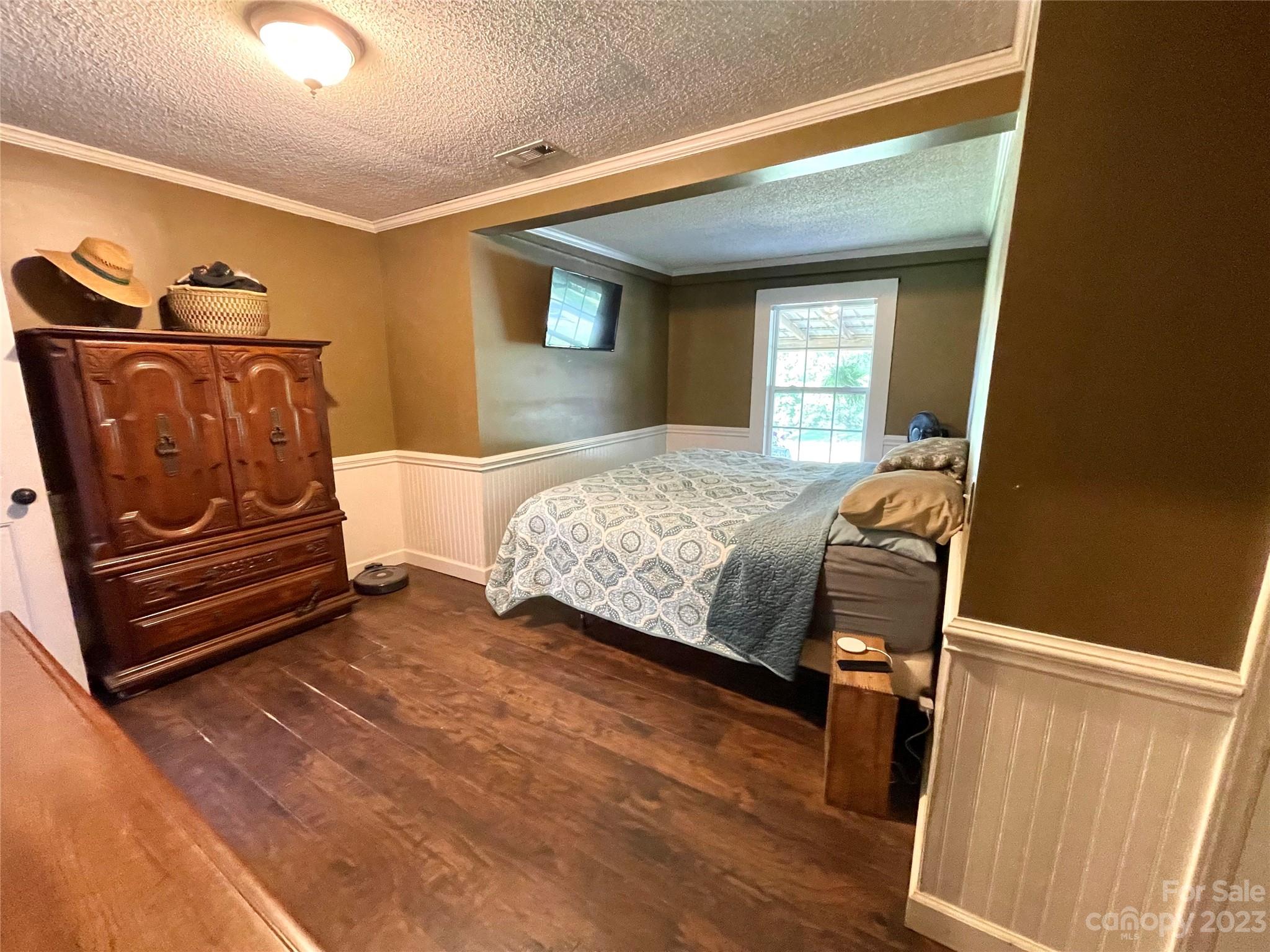 191 Lackey Road Hiddenite, NC 28636 - Photo 21 of 40 a bedroom with a bed and wooden floor