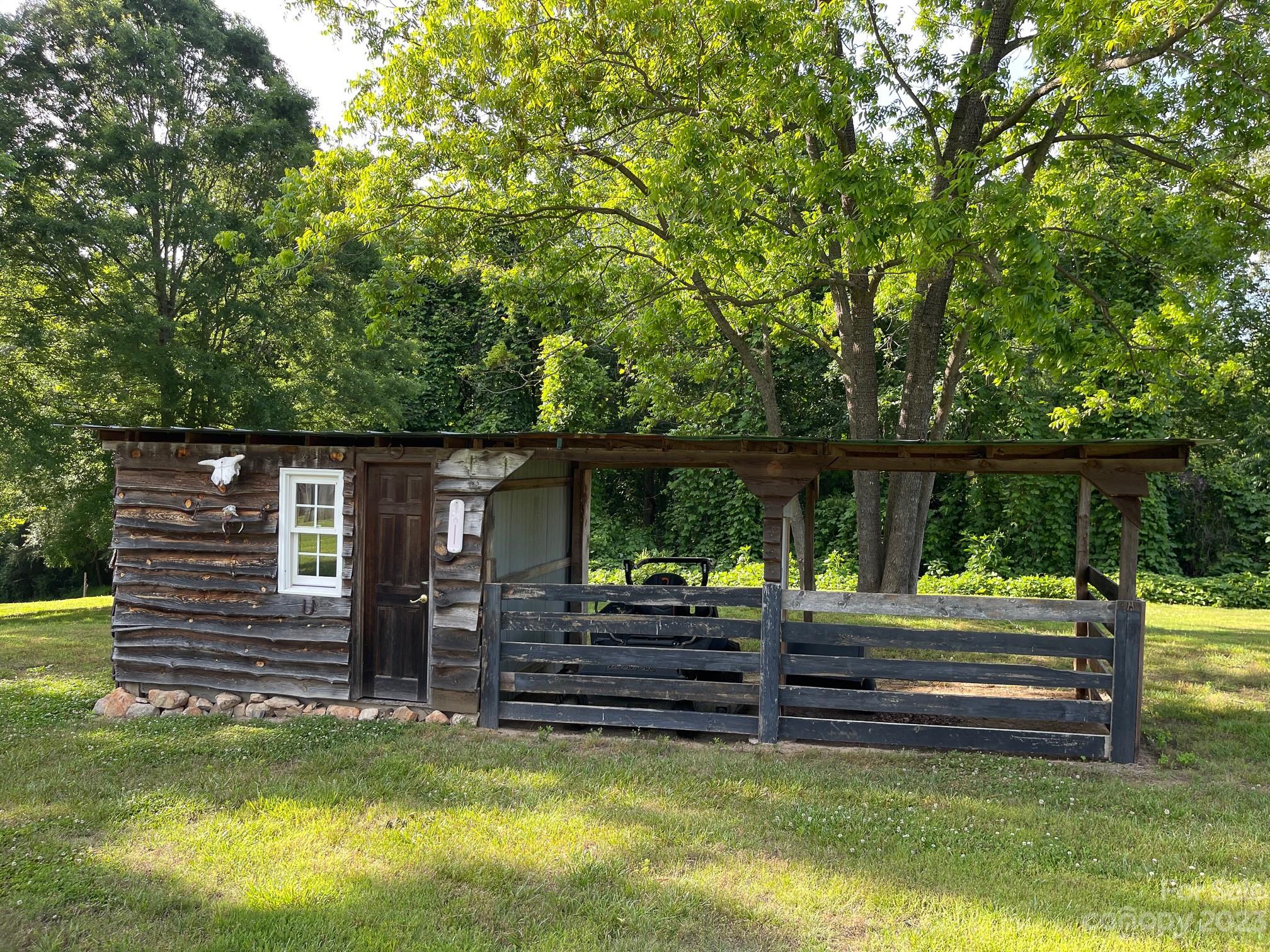 191 Lackey Road Hiddenite, NC 28636 - Photo 7 of 40 a backyard of a house with barbeque oven and view of a tree