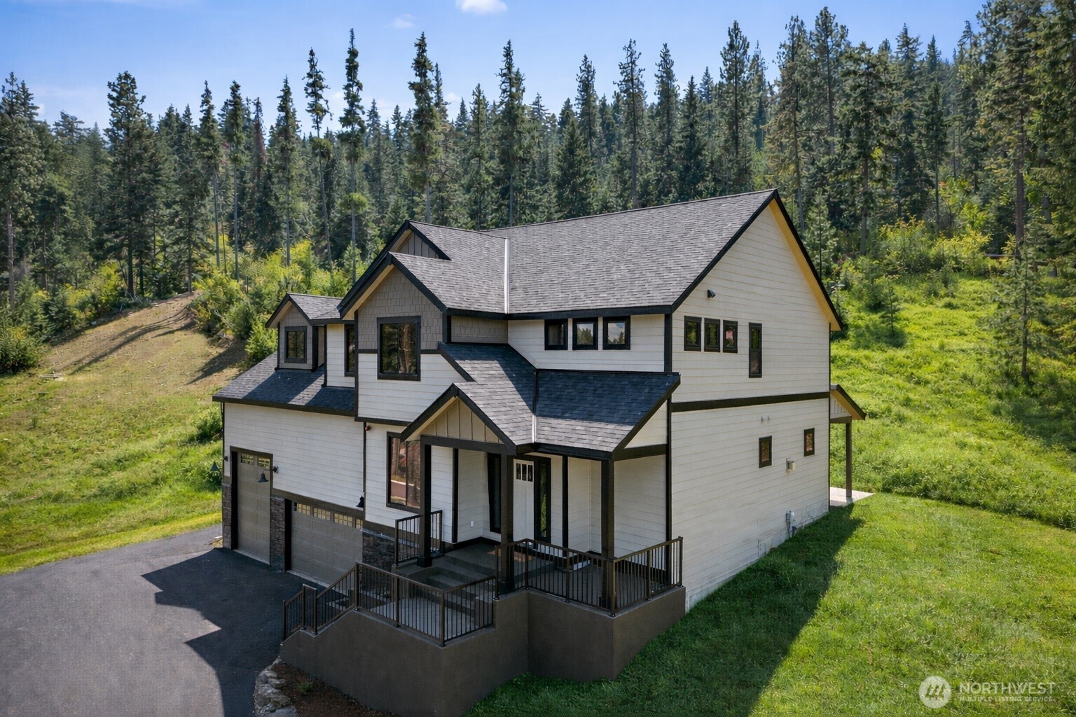 a aerial view of a house with swimming pool next to a yard