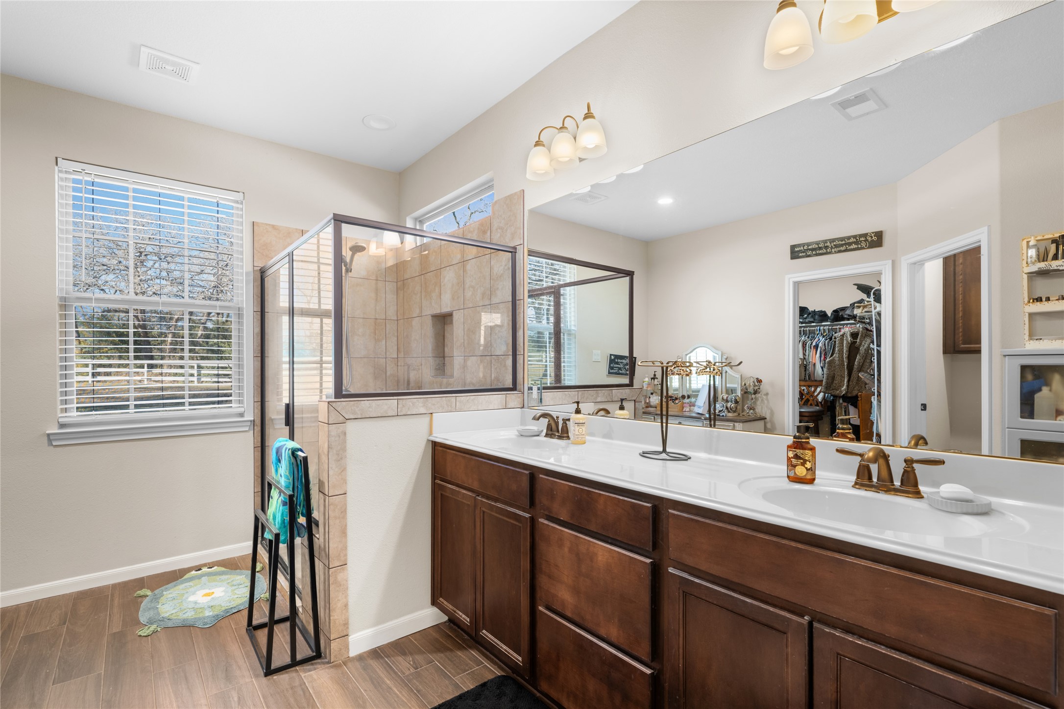 9467 Loop Road Bellville, TX 77418 - Photo 14 of 26 a bathroom with a double vanity sink and a mirror