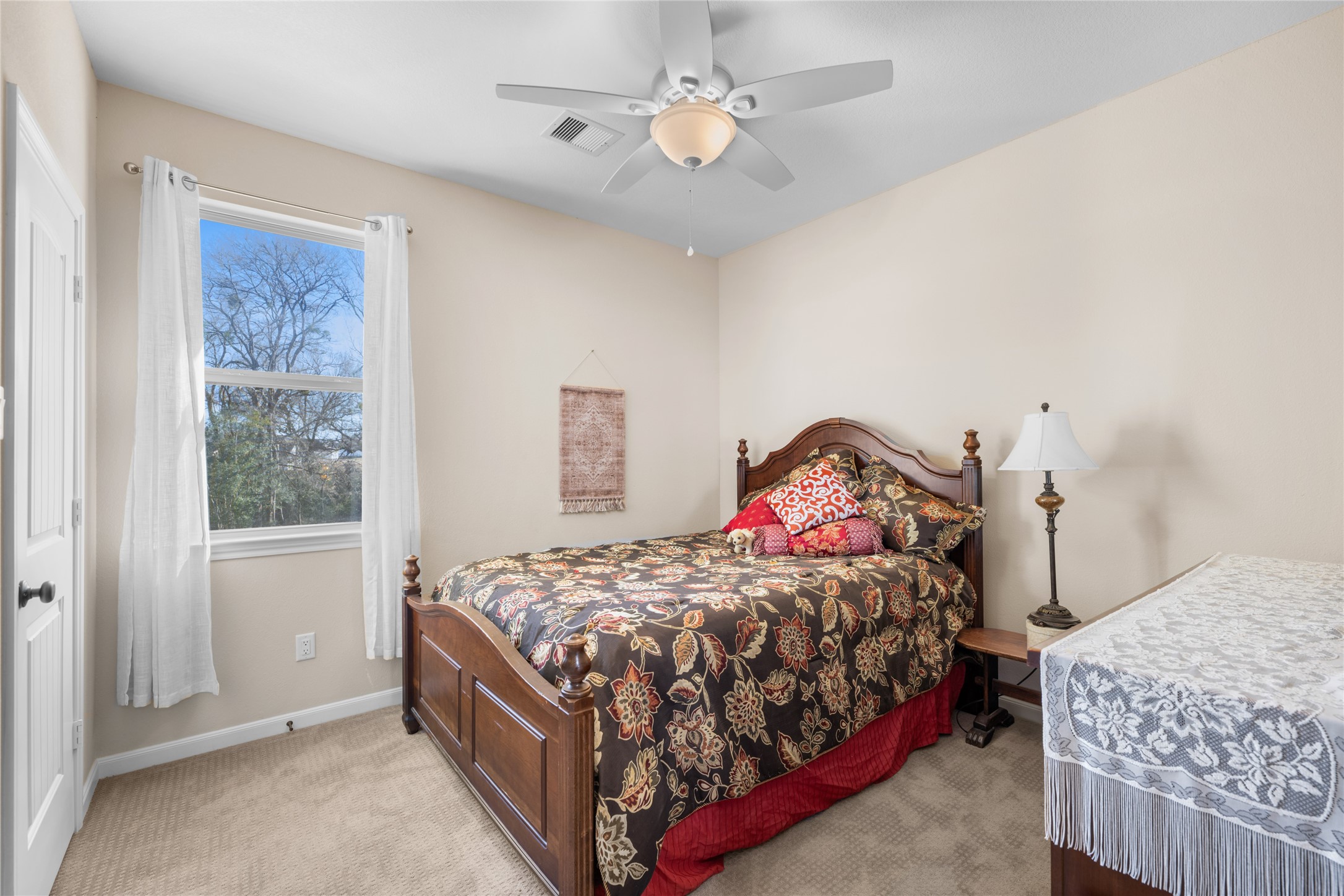 9467 Loop Road Bellville, TX 77418 - Photo 16 of 26 a bedroom with a bed and a chandelier