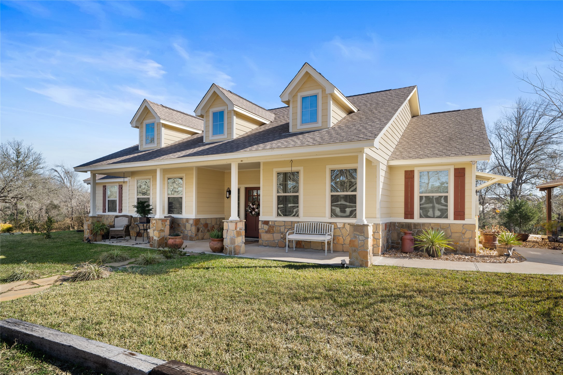 9467 Loop Road Bellville, TX 77418 - Photo 3 of 26 a front view of a house with garden and porch