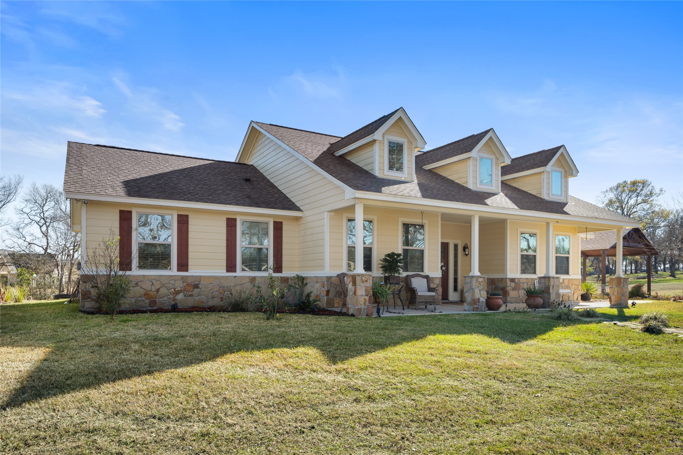 9467 Loop Road Bellville, TX 77418 - Photo 4 of 26 a front view of a house with a yard and outdoor seating