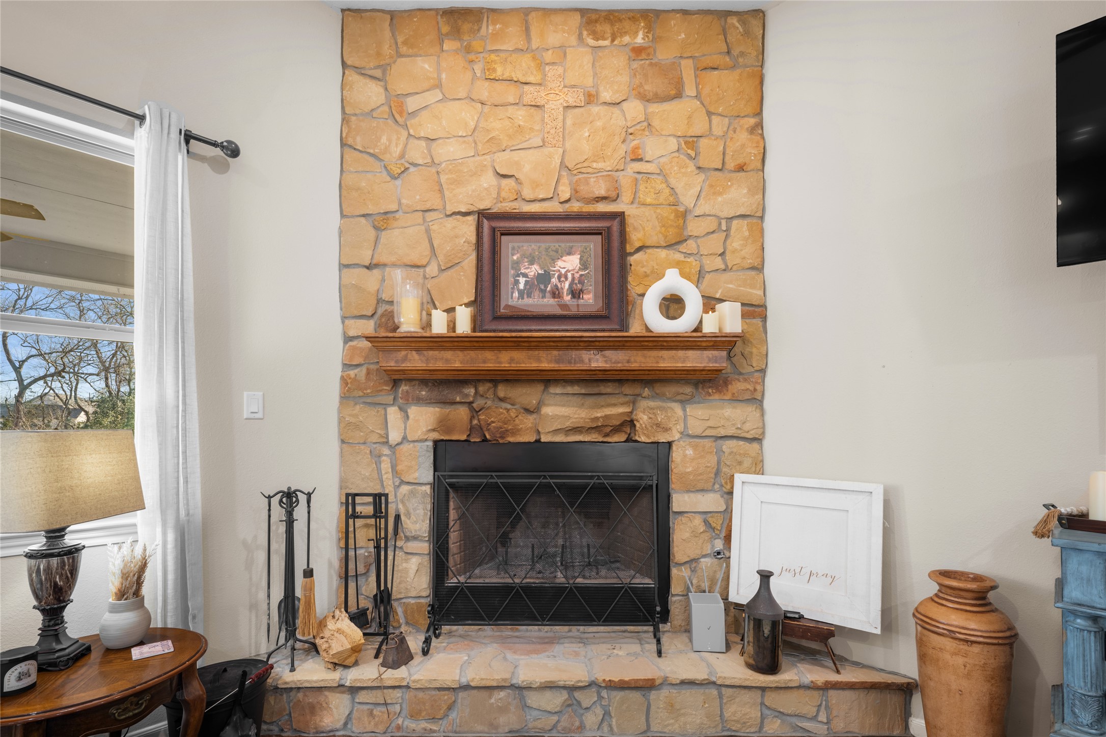 9467 Loop Road Bellville, TX 77418 - Photo 8 of 26 a living room with a fireplace and a flat screen tv