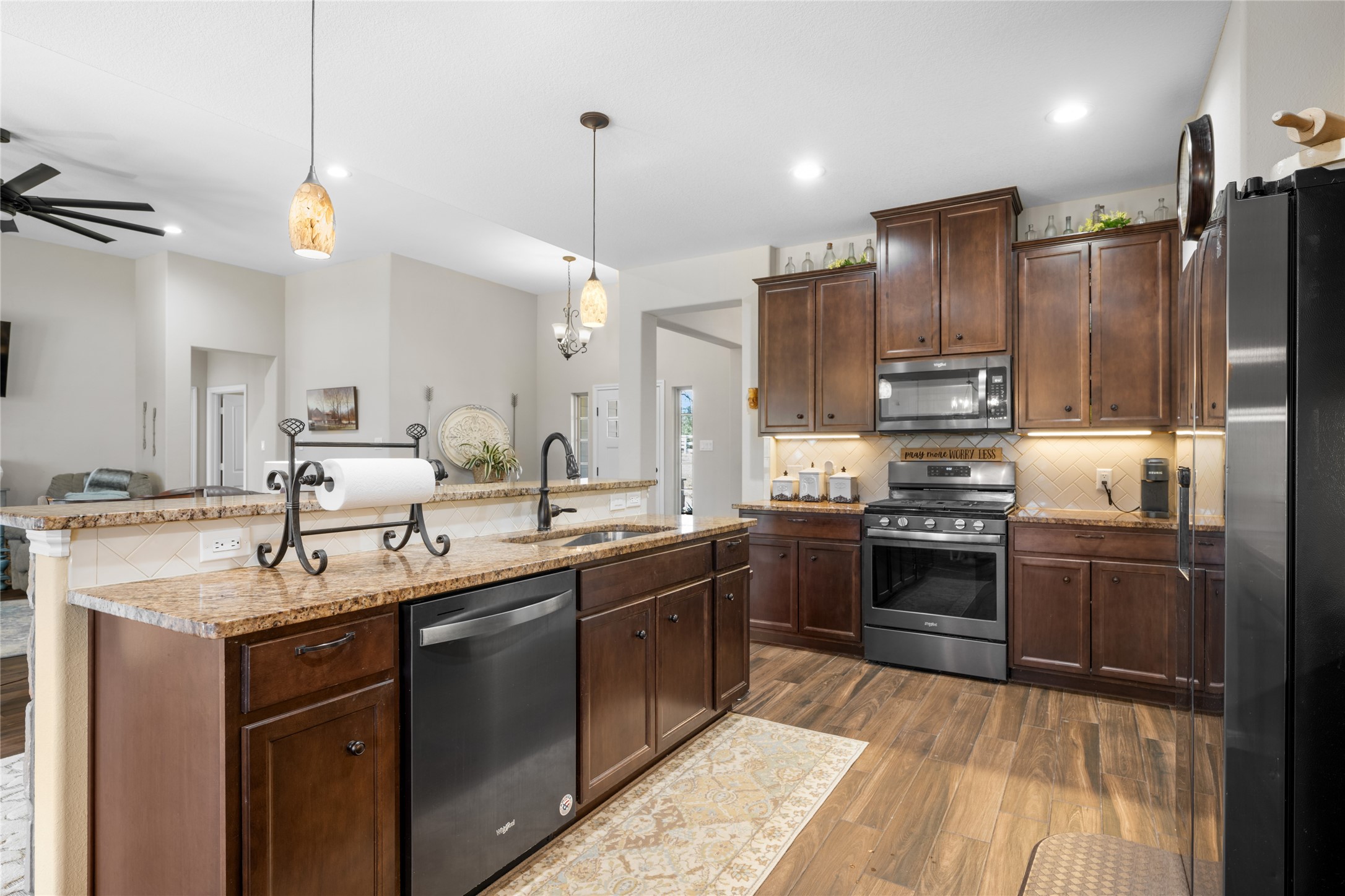9467 Loop Road Bellville, TX 77418 - Photo 9 of 26 a kitchen with stainless steel appliances a sink stove and refrigerator