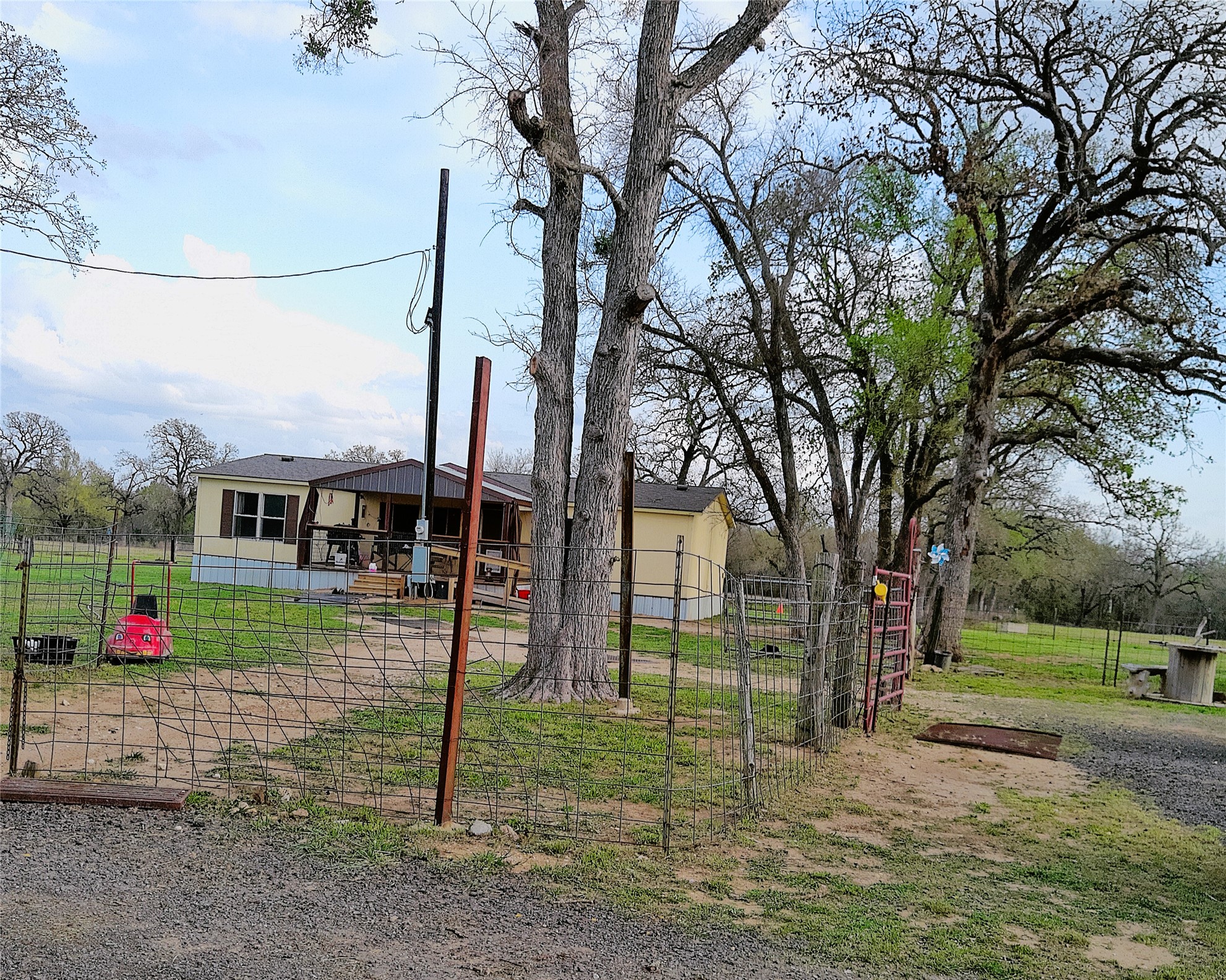 1042 Los Ranchitos Road Cameron, TX 76520 - Photo 14 of 40 a green field with lots of trees in the background