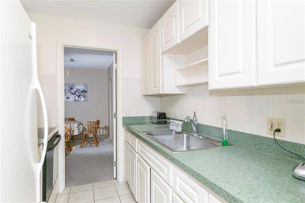 4932 Ilener Street New Port Richey, FL 34652 - Photo 9 of 38 a kitchen with stainless steel appliances granite countertop a sink stove and cabinets