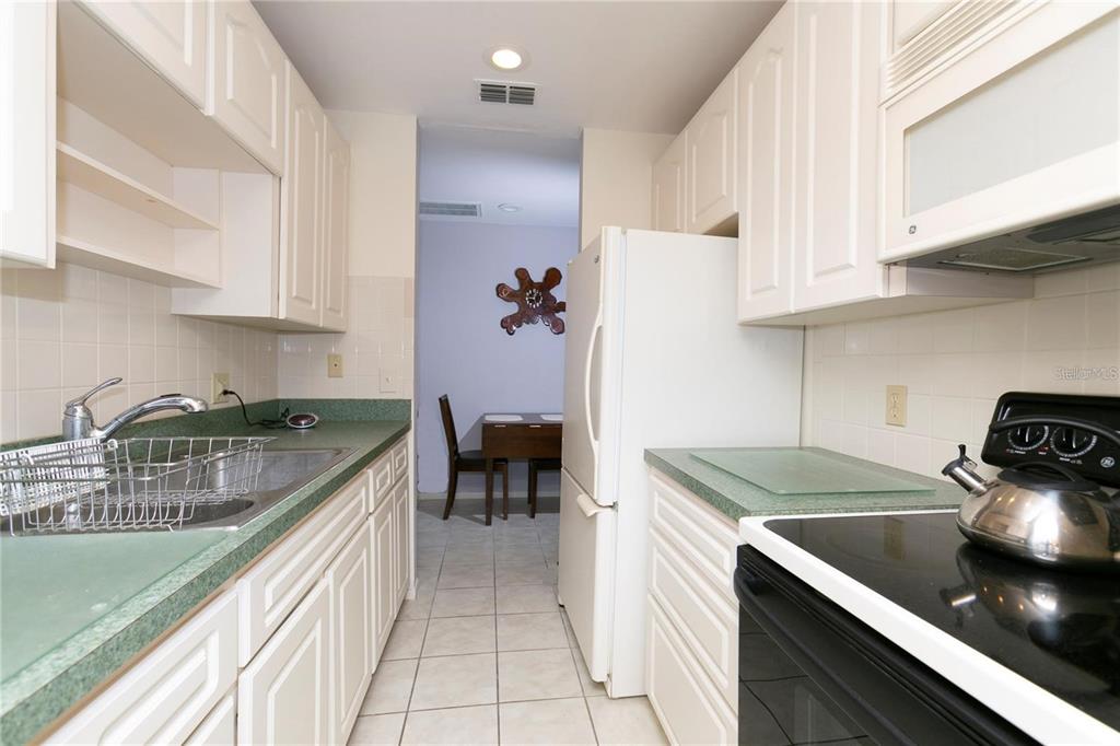 4932 Ilener Street New Port Richey, FL 34652 - Photo 10 of 38 a kitchen with a sink stove and cabinets