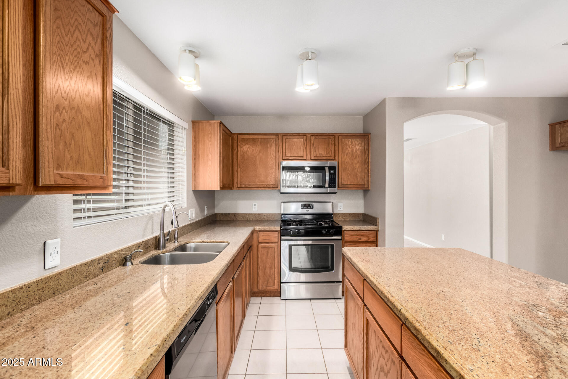 3822 West Fallen Leaf Lane Glendale, AZ 85310 - Photo 11 of 35 a kitchen with stainless steel appliances granite countertop a sink stove and refrigerator