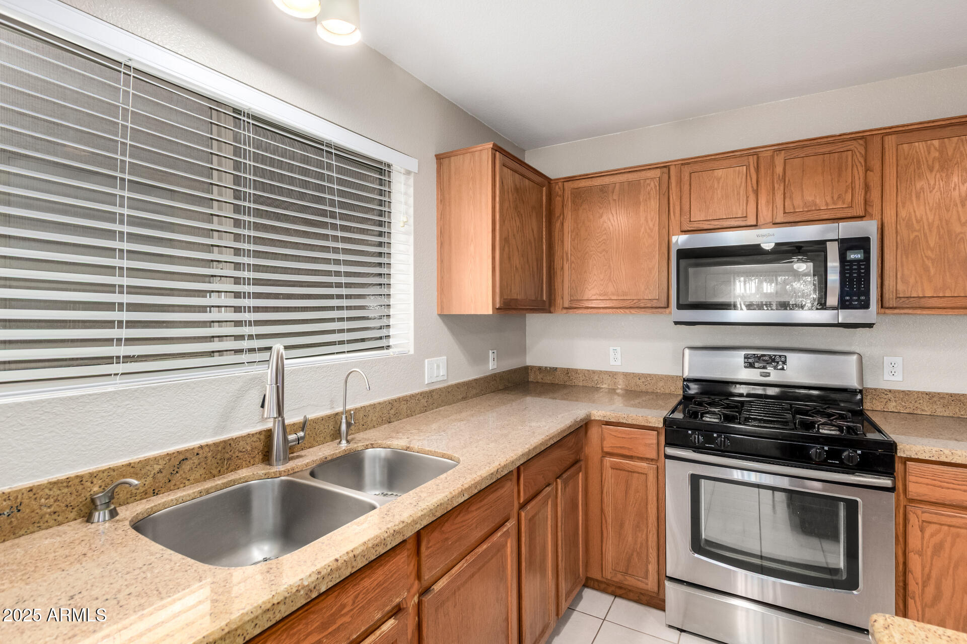 3822 West Fallen Leaf Lane Glendale, AZ 85310 - Photo 12 of 35 a kitchen with granite countertop a sink stove and microwave