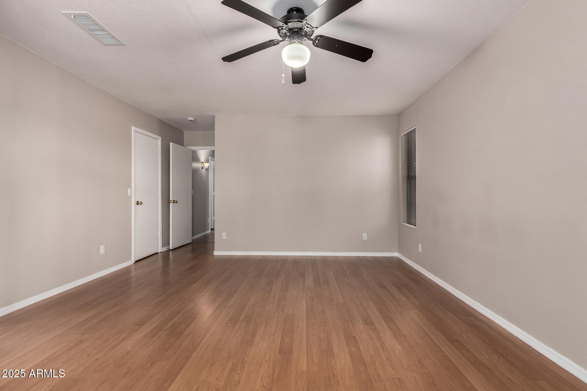 3822 West Fallen Leaf Lane Glendale, AZ 85310 - Photo 15 of 35 wooden floor in an empty room with a window