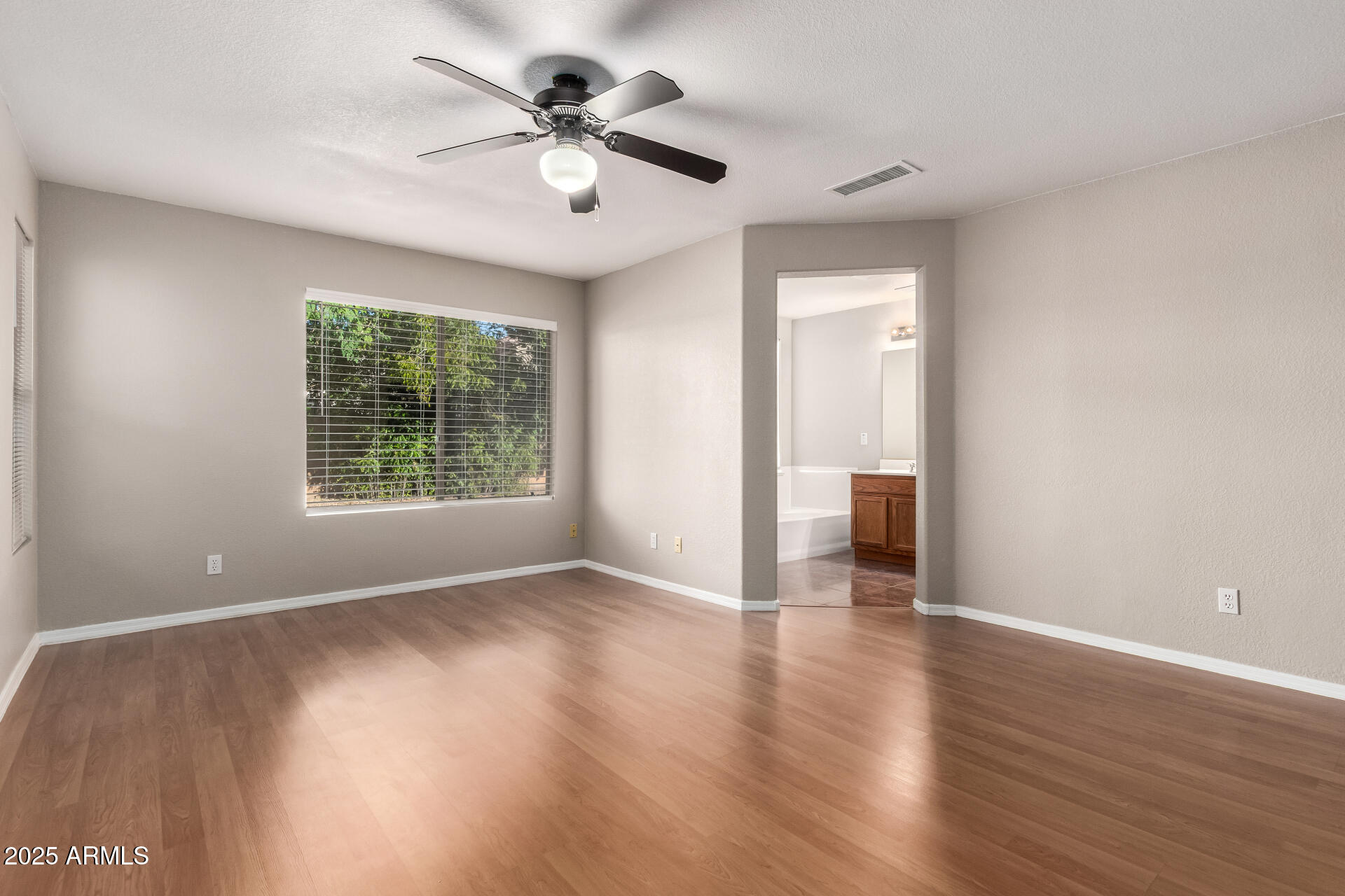 3822 West Fallen Leaf Lane Glendale, AZ 85310 - Photo 16 of 35 an empty room with wooden floor and windows