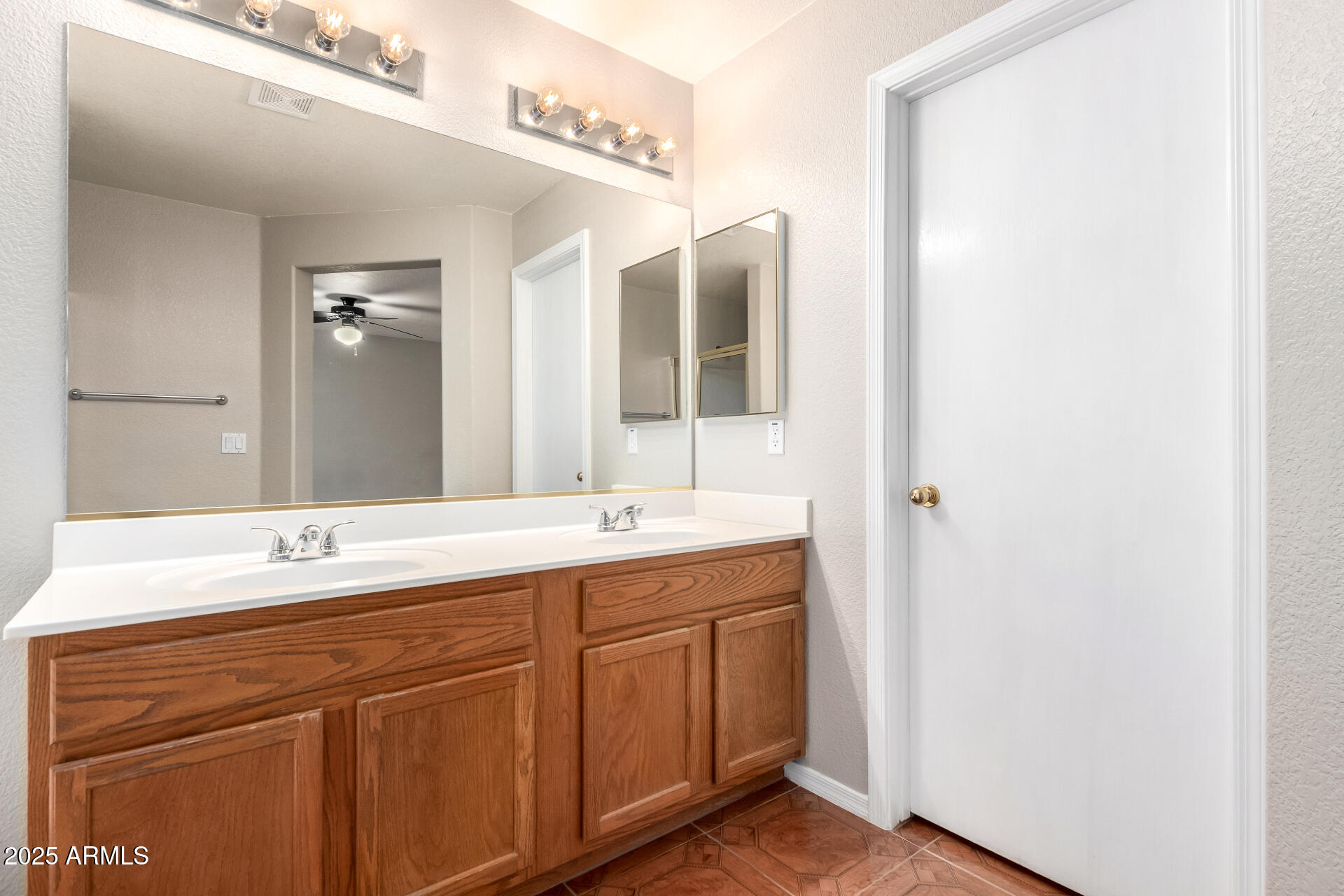 3822 West Fallen Leaf Lane Glendale, AZ 85310 - Photo 18 of 35 a bathroom with a double vanity sink and a mirror