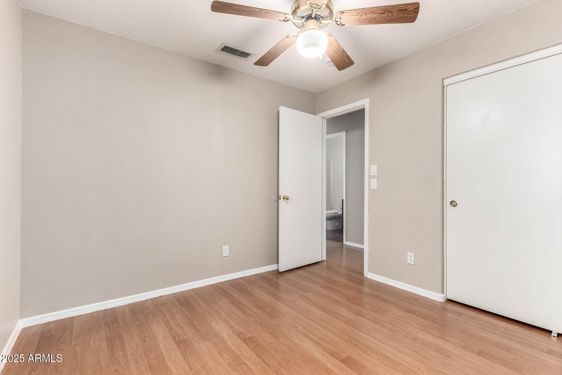 3822 West Fallen Leaf Lane Glendale, AZ 85310 - Photo 21 of 35 a view of an empty room with wooden floor