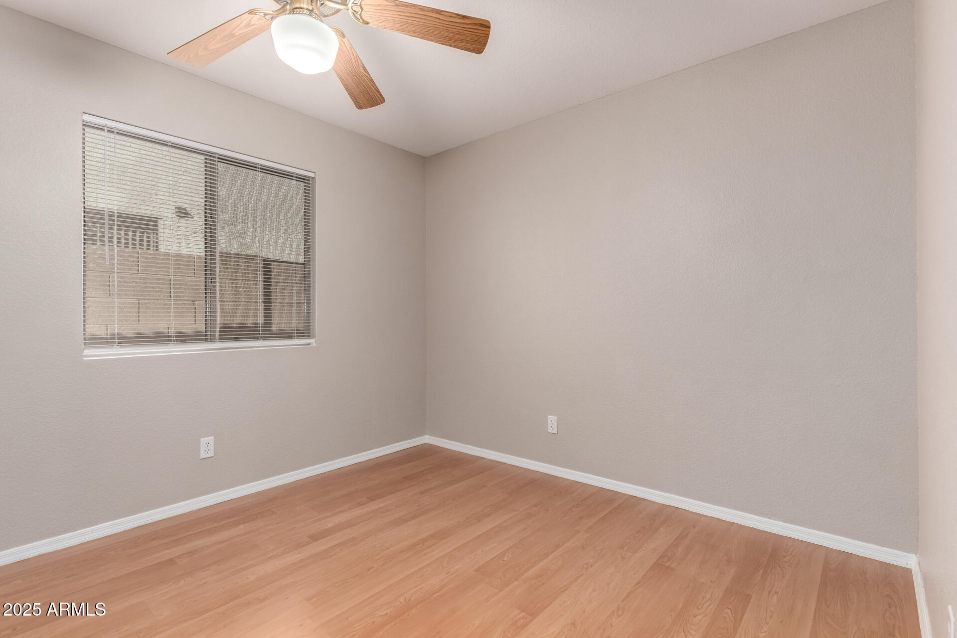 3822 West Fallen Leaf Lane Glendale, AZ 85310 - Photo 22 of 35 an empty room with wooden floor and windows
