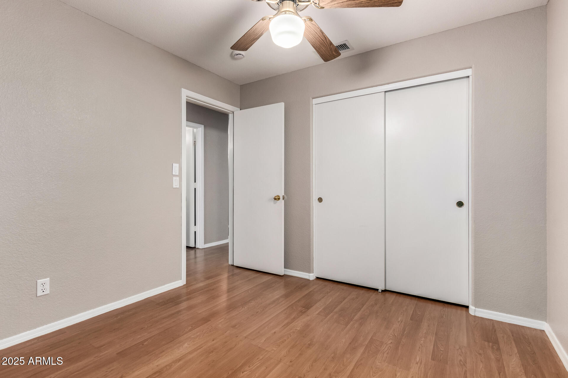 3822 West Fallen Leaf Lane Glendale, AZ 85310 - Photo 23 of 35 an empty room with wooden floor and windows