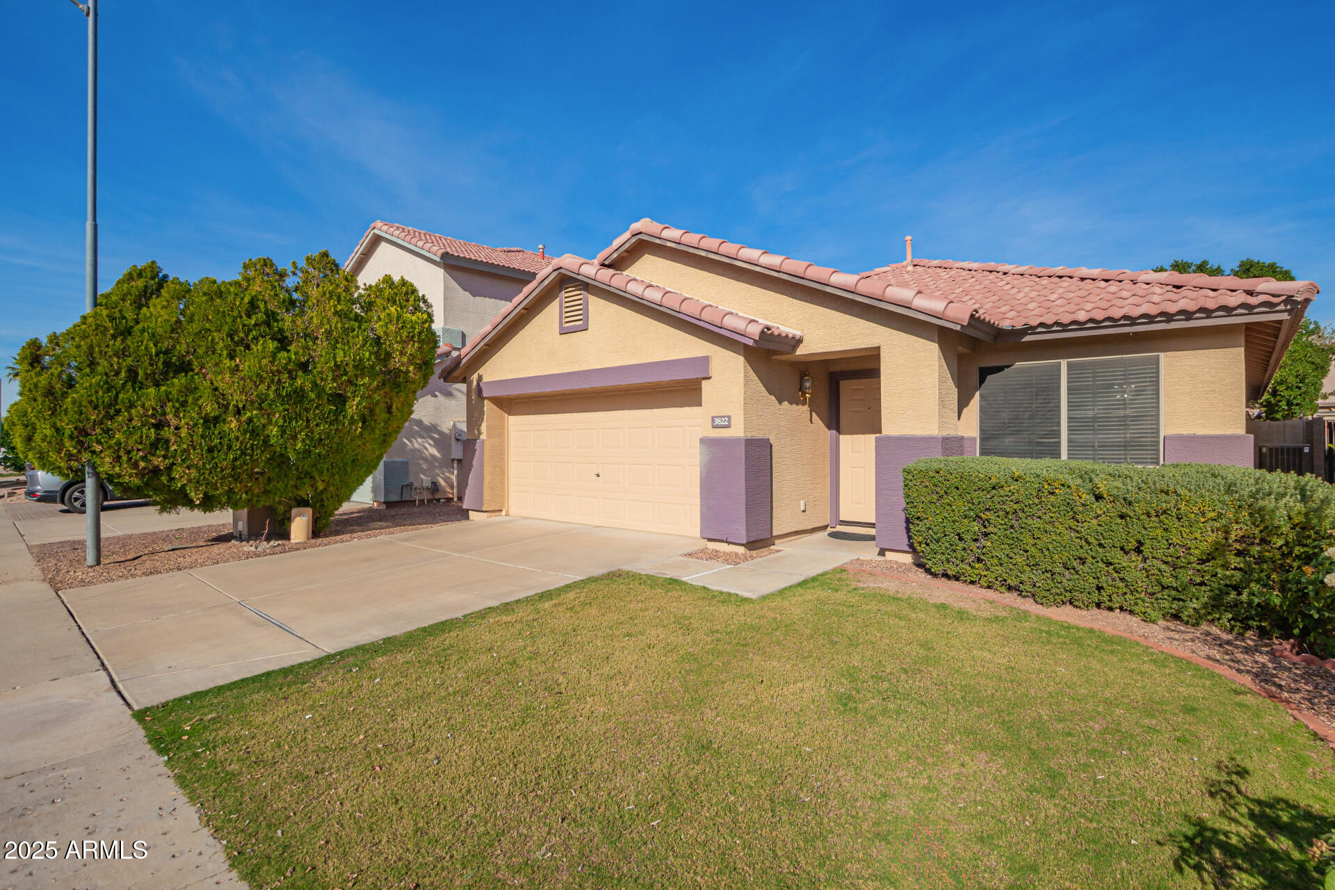 3822 West Fallen Leaf Lane Glendale, AZ 85310 - Photo 3 of 35 a front view of a house with a yard and garage
