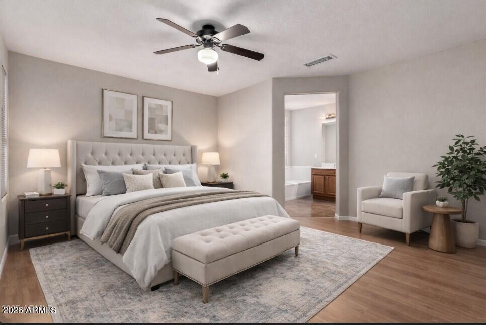 3822 West Fallen Leaf Lane Glendale, AZ 85310 - Photo 34 of 35 a spacious bedroom with a bed a couch and a potted plant