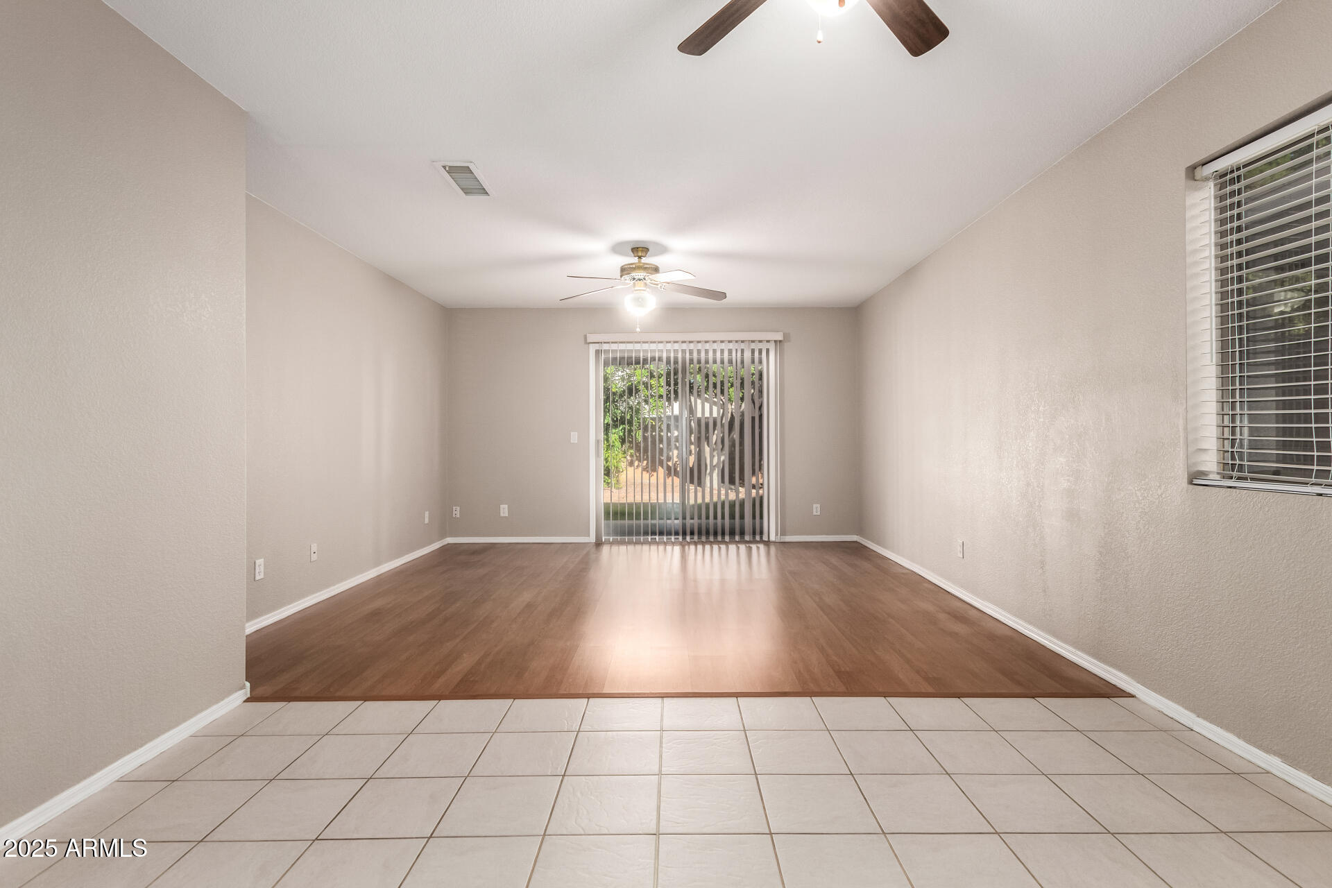 3822 West Fallen Leaf Lane Glendale, AZ 85310 - Photo 4 of 35 an empty room with windows and chandelier fan