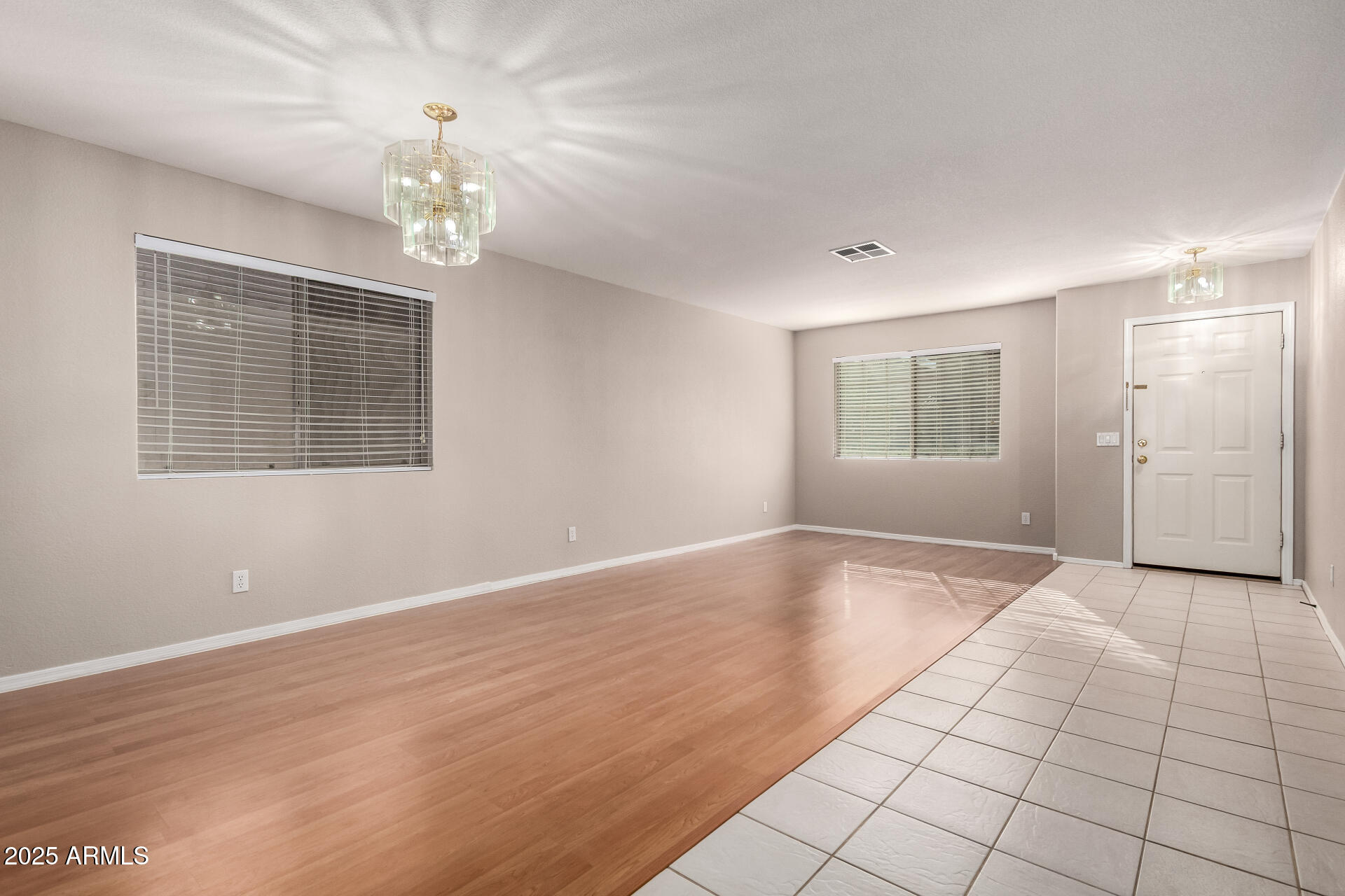 3822 West Fallen Leaf Lane Glendale, AZ 85310 - Photo 6 of 35 a view of an empty room with a window and wooden floor