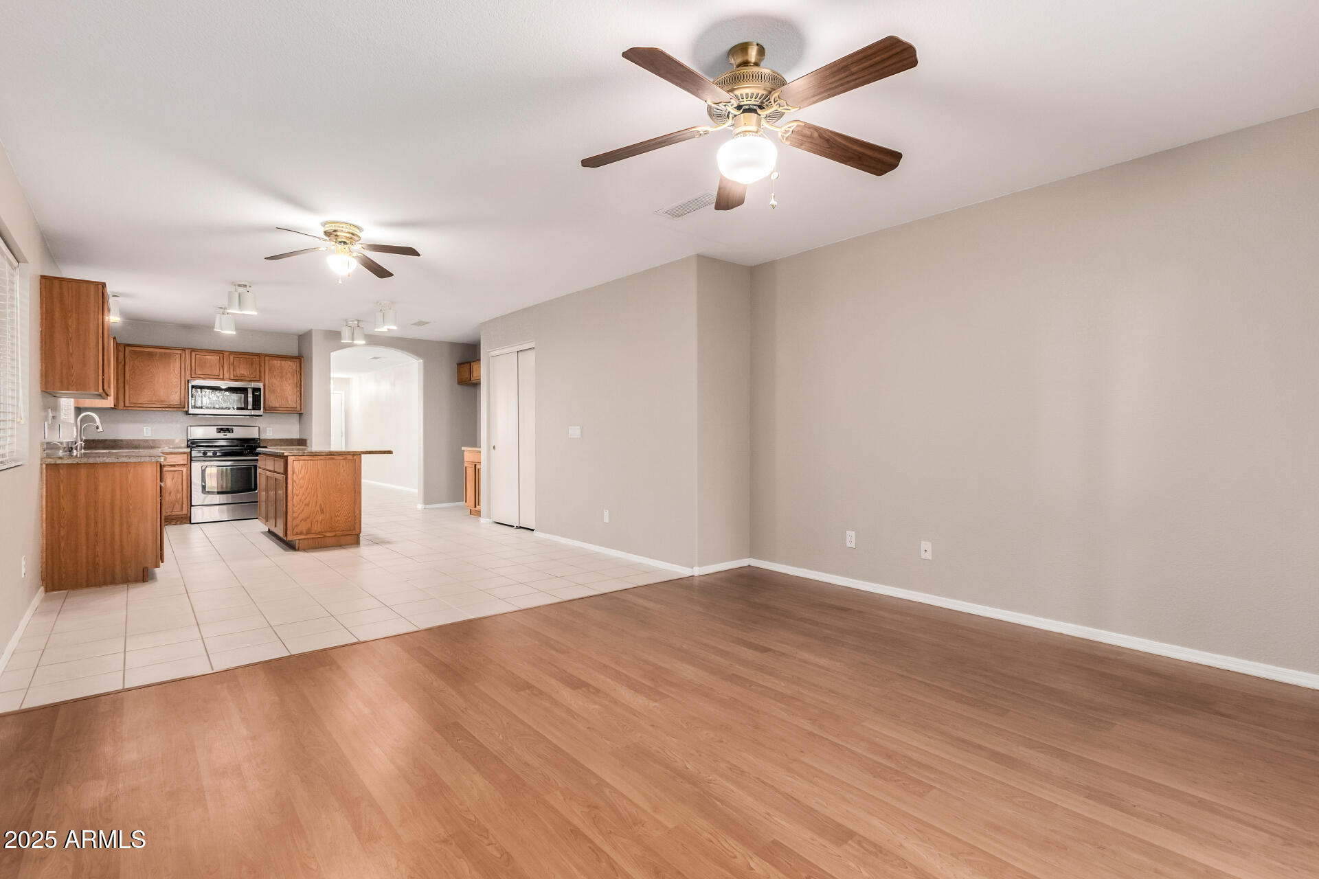 3822 West Fallen Leaf Lane Glendale, AZ 85310 - Photo 8 of 35 a view of a kitchen with a dishwasher a kitchen island hardwood floor and a ceiling fan