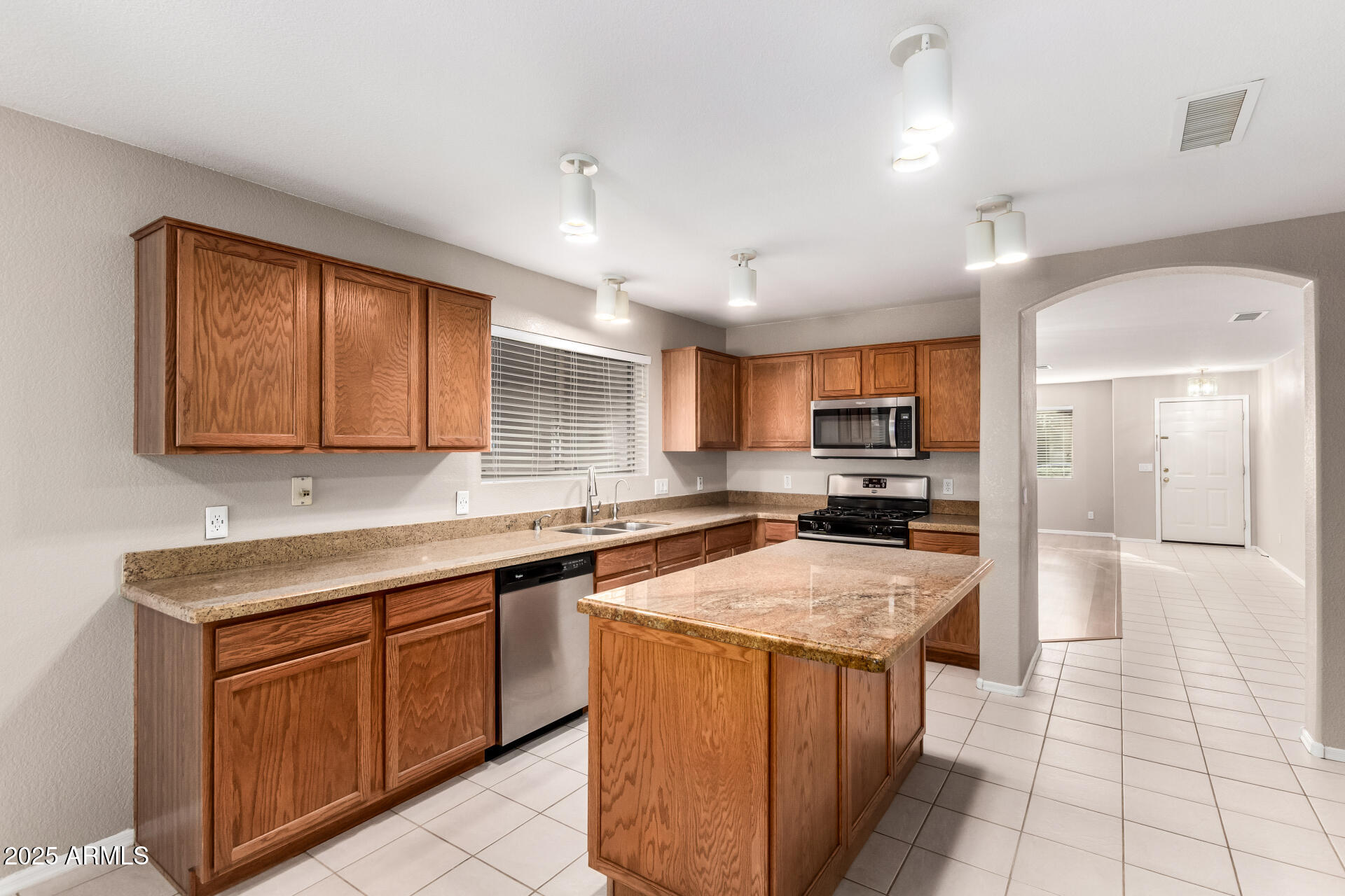 3822 West Fallen Leaf Lane Glendale, AZ 85310 - Photo 9 of 35 a kitchen with stainless steel appliances granite countertop a sink counter space cabinets and a large window