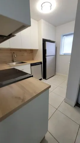 a kitchen with stainless steel appliances a refrigerator and sink
