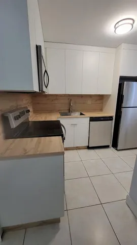 a kitchen with a sink a stove and a microwave