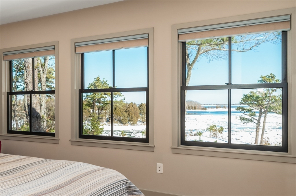 15 Lufkin Point Road Essex, MA 01929 - Photo 11 of 41 a bedroom with a large window and a bed