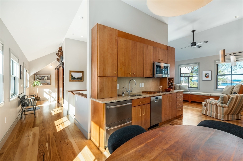 15 Lufkin Point Road Essex, MA 01929 - Photo 13 of 41 a kitchen with stainless steel appliances granite countertop a stove top oven a sink dishwasher and cabinets with wooden floor