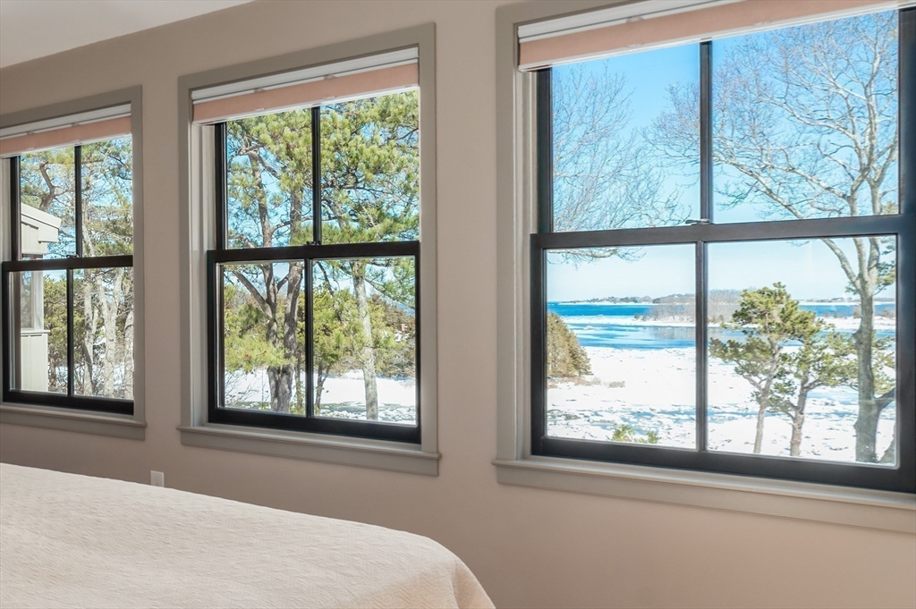15 Lufkin Point Road Essex, MA 01929 - Photo 20 of 41 a bedroom with a large window and a bed