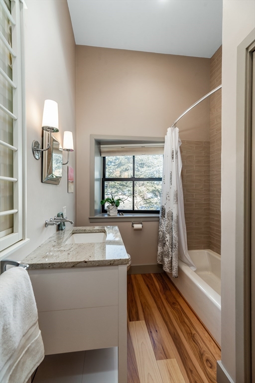 15 Lufkin Point Road Essex, MA 01929 - Photo 24 of 41 a bathroom with a granite countertop sink a bathtub window and shower