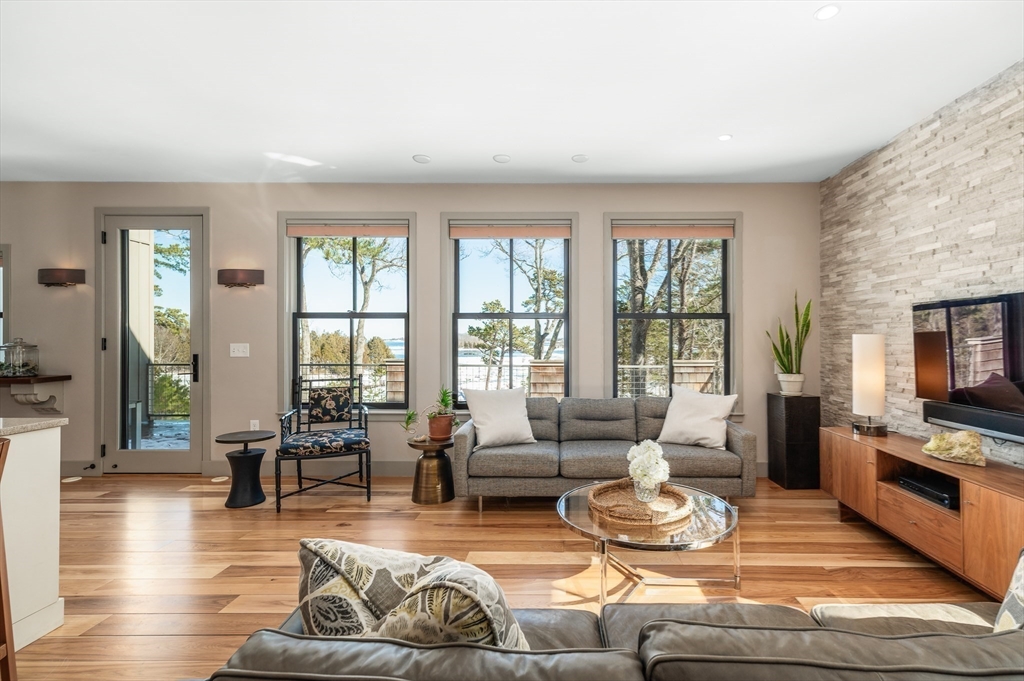 15 Lufkin Point Road Essex, MA 01929 - Photo 4 of 41 a living room with fireplace furniture and floor to ceiling windows