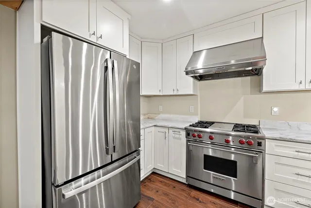 a kitchen with stainless steel appliances a stove and a refrigerator