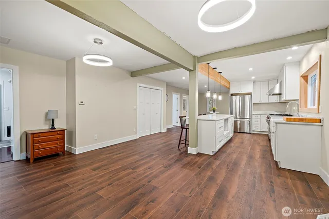 a view of a kitchen with furniture and wooden floor