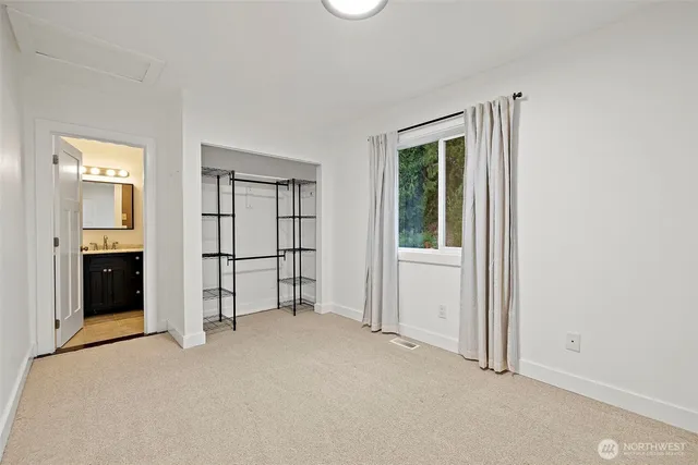 an empty room with windows and closet