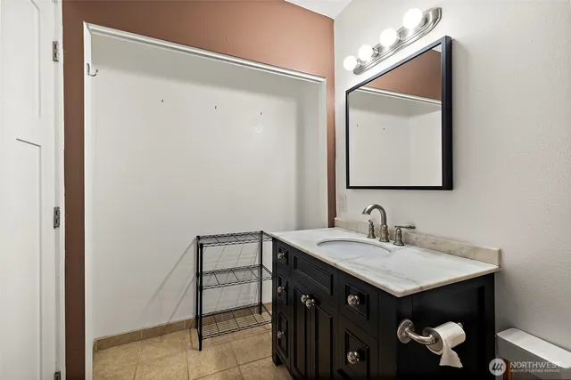 a bathroom with a sink vanity and a mirror