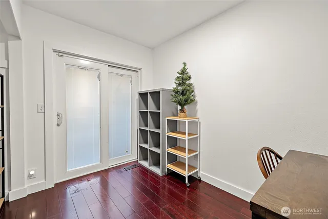 a view of wooden floor and windows in a room