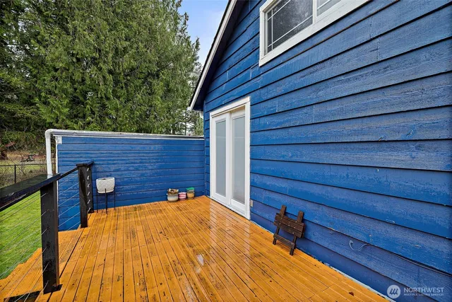 a view of a backyard room with wooden floor and fence