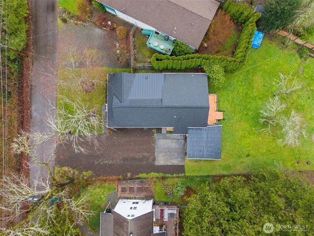 an aerial view of a house with a yard