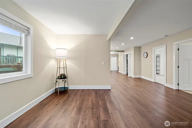 a view of empty room with wooden floor