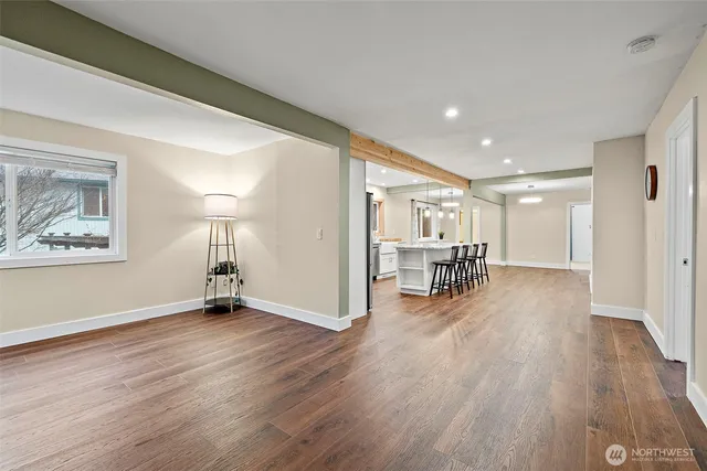 a view of a livingroom with wooden floor and a ceiling fan