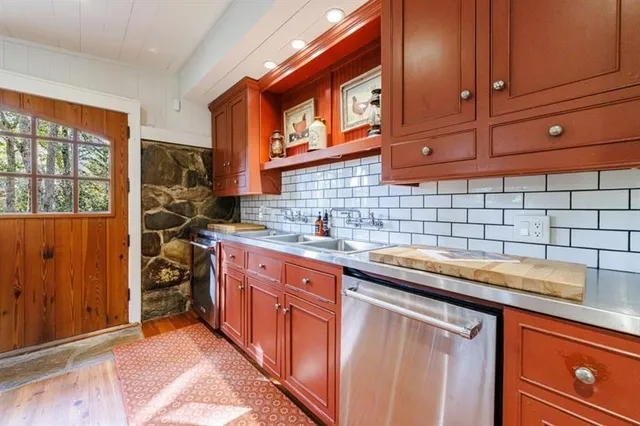 a bedroom with a bed wooden floor and window