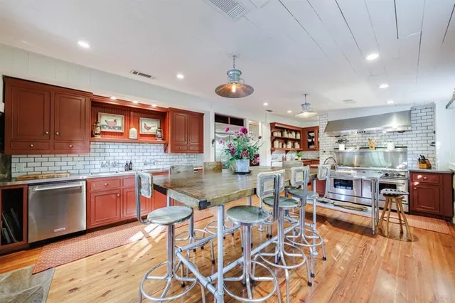 a bedroom with a large bed chandelier and a window